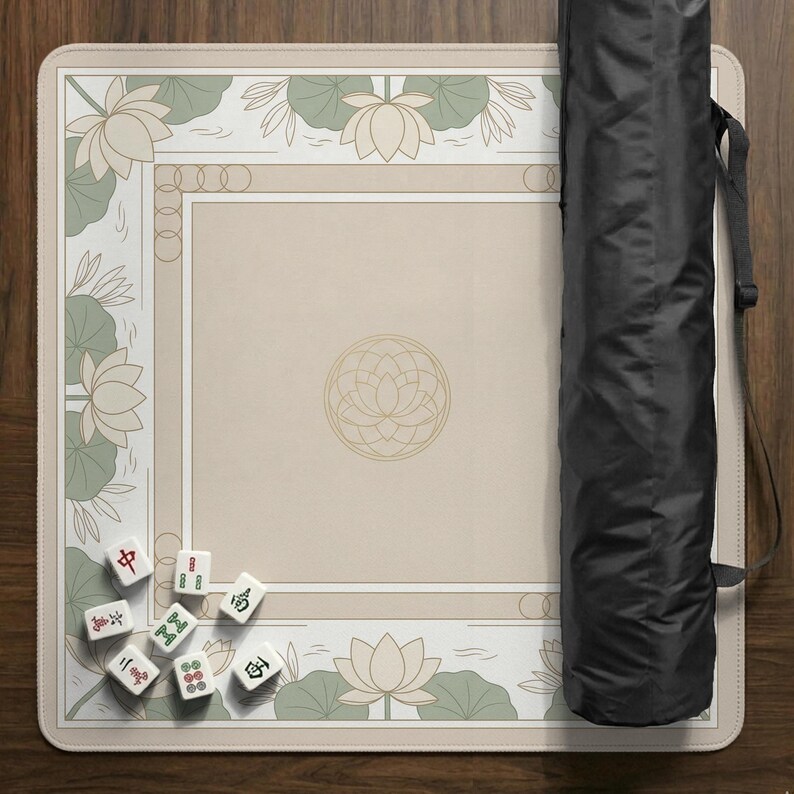 May include: A beige Mahjong game mat with a floral design and a black carrying case. The mat features lotus flowers and a geometric pattern. Several Mahjong tiles are scattered on the mat.