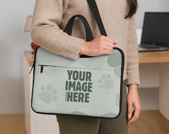 May include: A light green laptop bag with a black handle and shoulder strap. The bag features a design of paw prints and circles, with the text "YOUR IMAGE HERE" in dark green.