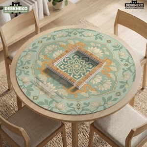 May include: A round table mat featuring a light green background with a repeating pattern of golden dragons, white lotus flowers, and green foliage. A square wooden frame sits in the center, displaying a geometric floral design on the mat surface.