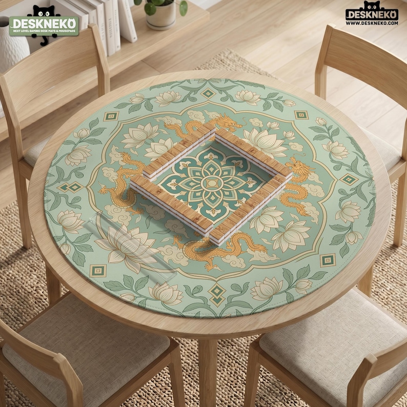 May include: A round table mat featuring a light green background with a repeating pattern of golden dragons, white lotus flowers, and green foliage. A square wooden frame sits in the center, displaying a geometric floral design on the mat surface.