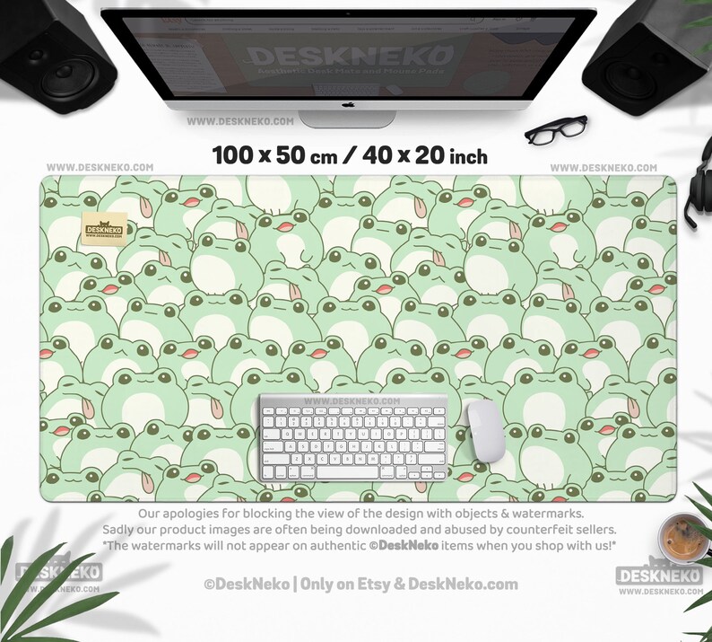 May include: A large desk mat featuring a repeating pattern of light green cartoon frogs. The mat is 40 inches long and 20 inches wide, with a white keyboard and mouse on top. The text "DESKNEKO" and "www.DESKNEKO.COM" are visible.