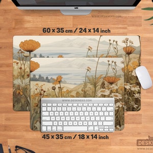 May include: Two rectangular desk mats featuring a floral landscape design. The larger mat measures 60 x 35 cm, and the smaller one is 45 x 35 cm. A white keyboard and mouse are on the wooden desk. The website address is visible.