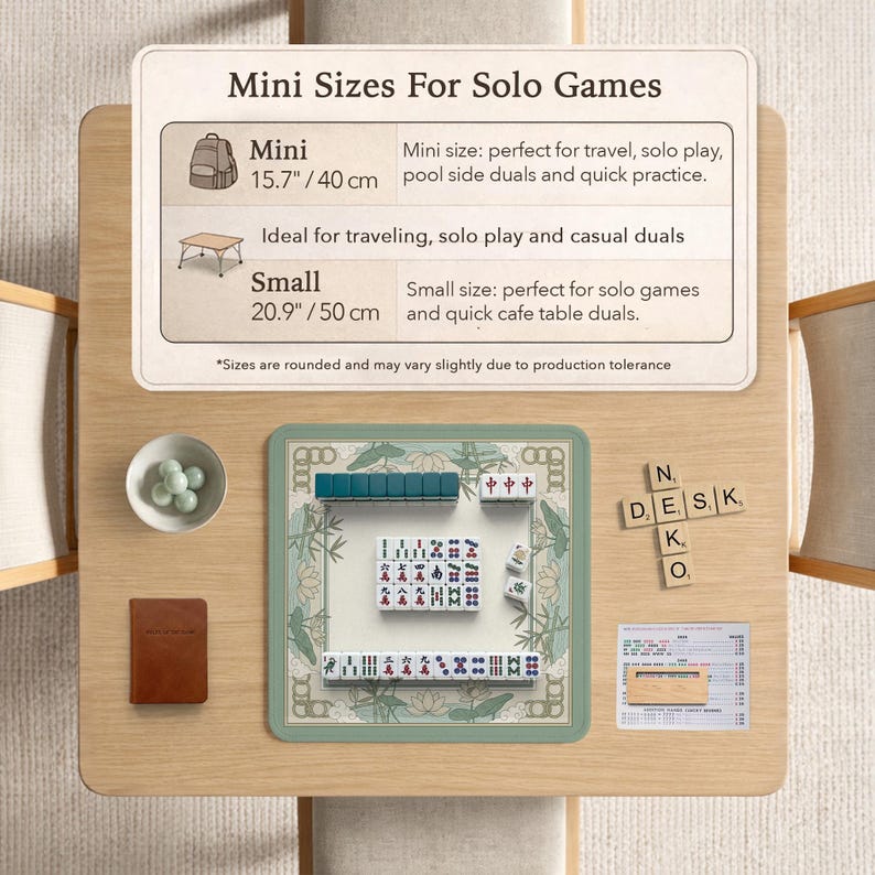 May include: A wooden table displays a mini Mahjong set with green tiles and a decorative border. The set includes a small brown notebook, a bowl of green stones, and a sign indicating mini and small sizes, 15.7" and 20.9" respectively.