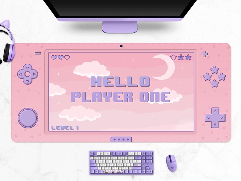 K&ouml;nnte beinhalten: Rosa Gaming-Mauspad mit Controller-Design. Das Mauspad zeigt den Text "HELLO PLAYER ONE" in pixeligen lila Buchstaben sowie Pixel-Art-Wolken, Sterne und einen Mond. Eine passende Tastatur und Maus sind ebenfalls sichtbar.