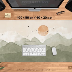 May include: A rectangular desk mat with a watercolor landscape design. The mat features a mountain range in shades of green and a setting sun. The dimensions are 40 x 20 inches. The text "DeskNeko" and "www.DESKNEKO.COM" are visible.