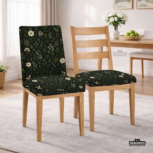 May include: Two wooden dining chairs. One chair has a dark green floral pattern on the seat and back. The other chair is a natural wood color with a slatted back. The chairs are in a well-lit room.