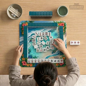May include: A person playing Mahjong on a wooden table. The game set includes white tiles with Chinese characters, teal tile racks, dice, and a small bowl. The game board features a beach scene with floral accents.