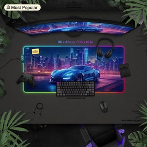 May include: A gaming desk mat with a neon-lit cityscape and a blue sports car design. The mat measures 35 x 16 inches and has a glowing edge. Accessories include a keyboard, mouse, controller, and headphones.