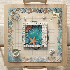 May include: A square wooden mahjong table with a beach-themed design. The center features a turquoise ocean scene with a starfish and coral. The border has seashells, pebbles, and the text "DESKNEKO". Mahjong tiles and dice are arranged on the table.