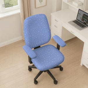 May include: A blue office chair with a star pattern. The chair has a black base with five wheels and armrests. The chair is in front of a white desk with a laptop.