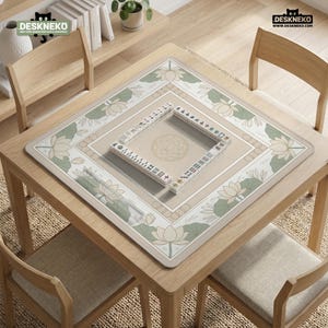 May include: A square wooden table with a beige mahjong mat featuring a lotus flower design. A set of mahjong tiles is arranged on the mat. The table is surrounded by four wooden chairs. The logo "DESKNEKO" is visible in the top left and right corners.