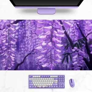 May include: A large, rectangular desk mat featuring a vibrant purple wisteria design. The image shows cascading purple flowers and green leaves. A matching purple keyboard, mouse, and monitor are also visible.