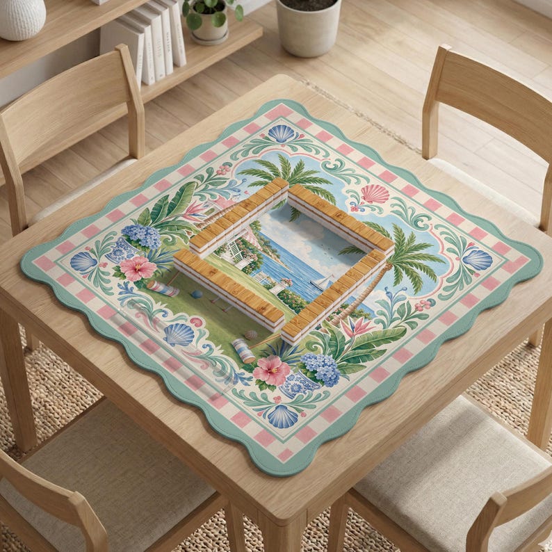 May include: A square table with a decorative mat featuring a tropical scene with a beach, palm trees, and flowers. The mat has a scalloped edge and a frame-like structure in the center.
