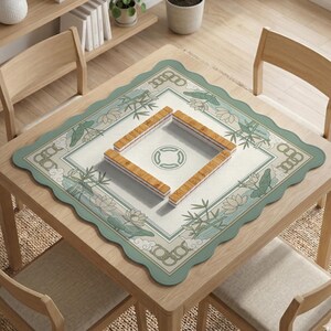 May include: A square wooden table with a decorative mat featuring a floral and bamboo design. The mat has a scalloped edge and surrounds a central square with a circular emblem. Four wooden mahjong tile racks are arranged on the mat.