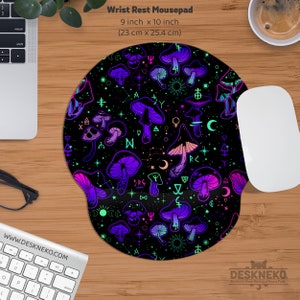 May include: Black wrist rest mousepad with a vibrant pattern of purple, pink, and green mushrooms and celestial symbols. The mousepad is 9 inches by 10 inches.