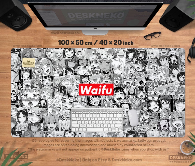 May include: A black and white desk mat featuring a collage of anime-style faces. The mat is rectangular, measuring 40 x 20 inches, with the word "Waifu" in a red box. A keyboard and mouse are on the mat.
