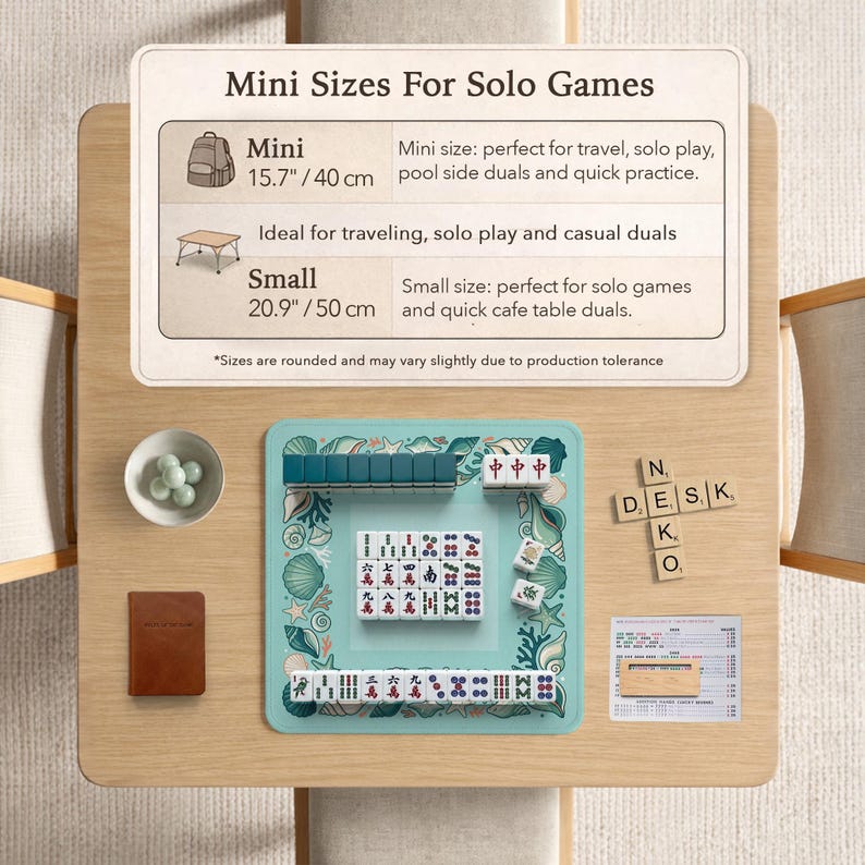 May include: A Mahjong set on a teal playing surface, with tiles, accessories, and a small brown notebook. The set is displayed on a wooden table. The sign reads "Mini Sizes For Solo Games". The playing surface is 40 cm x 50 cm.