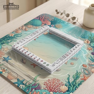 May include: A white Mahjong set arranged on a colorful mat with an ocean-themed design. The mat features illustrations of coral, seashells, and starfish. The game pieces are rectangular and display Chinese characters and symbols.