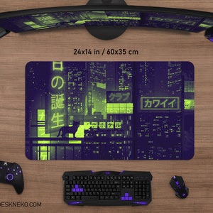 May include: A rectangular mouse pad with a neon cityscape design in purple and green, featuring Japanese text and a silhouette of a cat. The pad measures 24 x 14 inches.
