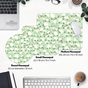 May include: Three mousepads in different sizes, featuring a repeating pattern of cartoon frogs in shades of green and white. The medium mousepad measures 12 x 10 inches, the small is 9 x 7 inches, and the round one is 8 inches in diameter.