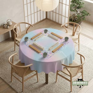 May include: A round table set for a game, covered with a pastel-colored tablecloth. The table is surrounded by wooden chairs. Mahjong tiles and small cups are arranged on the table. A paper lantern hangs above.