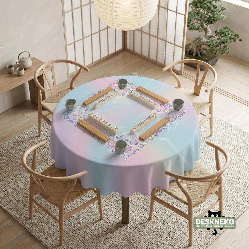 May include: A round table set for a game, covered with a pastel-colored tablecloth. The table is surrounded by wooden chairs. Mahjong tiles and small cups are arranged on the table. A paper lantern hangs above.