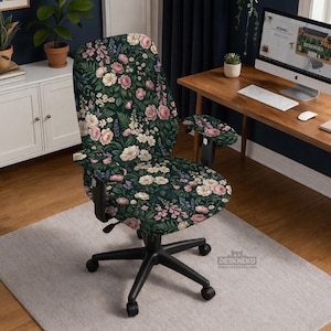 May include: An office chair with a floral pattern. The chair features a dark green background with pink, white, and purple flowers. The chair has a black base and armrests. The chair is on a light gray rug.