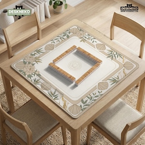 May include: A square wooden table with a beige floral and seashell patterned mat. Four wooden game pieces are arranged in a square in the center. The table is surrounded by four wooden chairs. The mat has a floral and seashell design.
