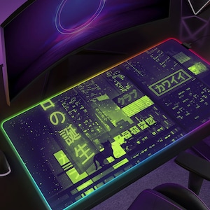 May include: A rectangular gaming mouse pad with a neon cityscape design. The pad features a black background with green and yellow accents, and Japanese text. A silhouette of a dog is visible. The pad has a colorful LED edge.