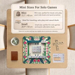 May include: A Mahjong set on a floral mat with peacock illustrations, featuring tiles with Chinese characters and symbols. A sign displays Mini Sizes For Solo Games, listing 15.7 inches and 20.9 inches, alongside a small bowl, a notebook, and wooden letter tiles.