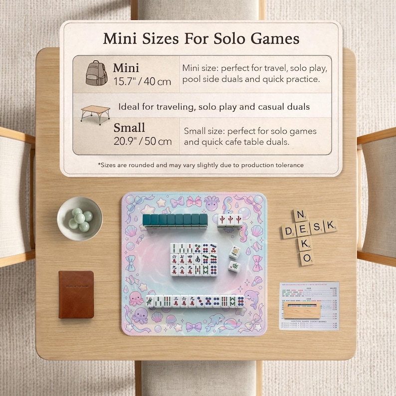May include: A wooden table with a pastel-colored Mahjong set, including tiles, dice, and a play mat. The mat features sea creatures and bow designs. A sign indicates mini sizes for solo games, with dimensions of 15.7 inches/40 cm and 20.9 inches/50 cm.