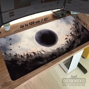 May include: A rectangular desk mat with a dark, artistic design. The mat features a central dark sphere, surrounded by silhouetted figures and birds against a cloudy sky. It measures up to 120 cm long and 60 cm wide.
