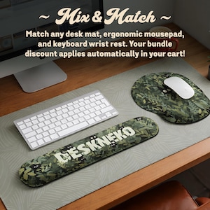 A product photo of a wooden desk featuring a coordinated "Mix & Match" ergonomic mousepad and keyboard wrist rest set from DeskNeko on Etsy. A large desk mat sits under a keyboard and mouse. Resting on it is a keyboard wrist rest and an ergonomic mousepad with a computer mouse. Both accessories feature an aesthetic design printed in high quality. The text above explains that bundle discounts apply automatically when you match any desk mat, ergonomic mouse pad, and wrist rest.