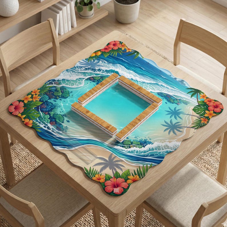May include: A square table mat with a scalloped edge featuring a tropical beach scene with blue ocean waves, sandy shores, palm trees, and colorful hibiscus flowers. A wooden square frame sits in the center of the mat on a wooden table.