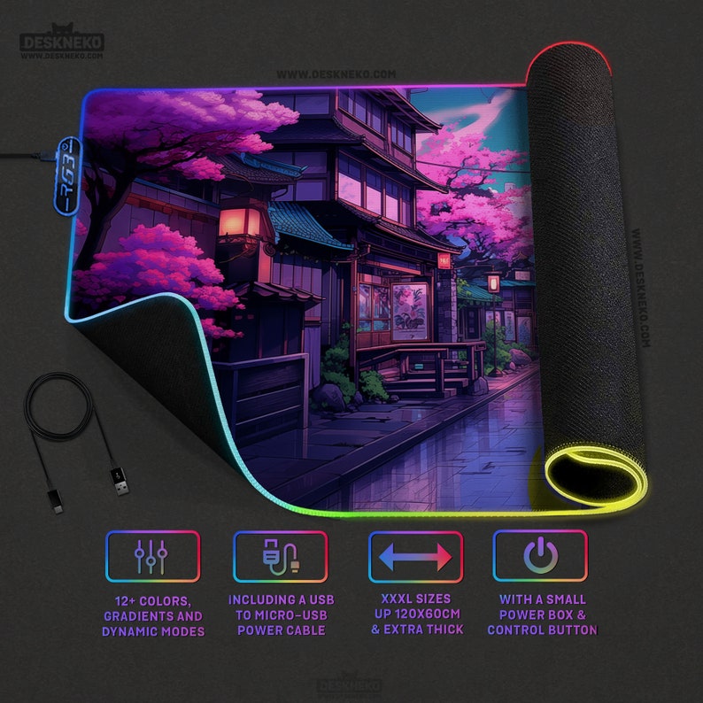 May include: An extra-large gaming mouse mat with a Japanese street scene and cherry blossom trees. The mat has a black surface with a colorful LED edge, a USB cable, and a control button. The mat is up to 120cm long and 60cm wide.