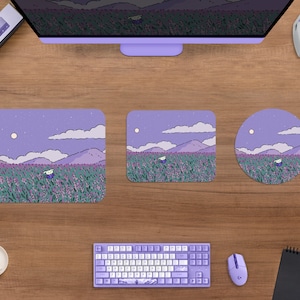 May include: A desktop setup featuring a purple-themed aesthetic. Includes a computer monitor, keyboard, mouse, and three mousepads of different shapes. The mousepads and monitor display a whimsical landscape with a figure in a field of flowers under a night sky.