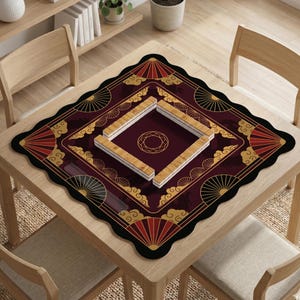 May include: A square Mahjong game mat with a burgundy background and a black scalloped border. The mat features gold and red fan and cloud designs. The centre has a diamond-shaped area with a gold circle. Wooden Mahjong tiles are arranged on the mat.