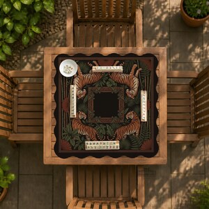 May include: A square, black and brown decorative table cover featuring a tiger design. The cover has a scalloped edge and is placed on a wooden table. The tiger design is surrounded by green foliage and text.