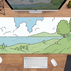 May include: A large rectangular desk mat featuring a cartoon landscape with a lake, green hills, and fluffy white clouds under a blue sky. The design includes trees and a small, white cat. The mat is on a wooden desk with a keyboard and mouse.