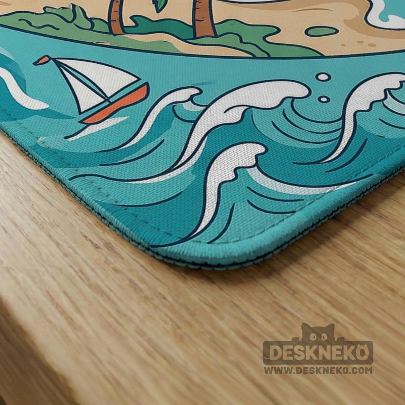 May include: A rectangular desk mat with a beach scene, including a sailboat on turquoise water and palm trees on a sandy shore. The mat has a blue border and the text "DESKNEKO" and "WWW.DESKNEKO.COM" in the bottom right corner.