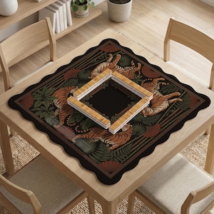 May include: A square black table mat with a scalloped edge, featuring a tiger and foliage design. The mat has a central square opening and is surrounded by a border of tigers, ferns, and bamboo. A set of wooden game pieces are placed on top.