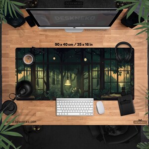 May include: A rectangular desk mat with a forest scene design, measuring 35 x 16 inches. The mat features a detailed illustration of a forest with trees, lights, and a window view. The text "DESKNEKO" and website address are visible.