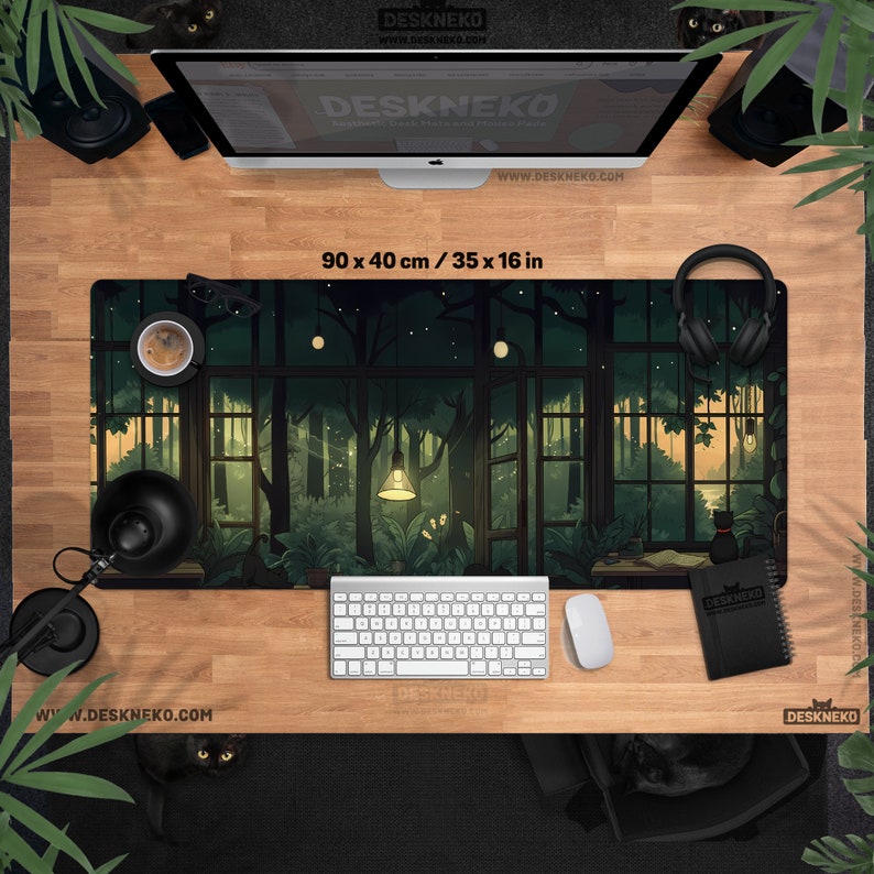May include: A rectangular desk mat with a forest scene design, measuring 35 x 16 inches. The mat features a detailed illustration of a forest with trees, lights, and a window view. The text "DESKNEKO" and website address are visible.