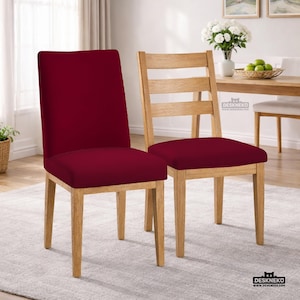 May include: Two dining chairs. One chair has a burgundy seat and back, with light wood legs. The other chair has a burgundy seat and a light wood ladder back. Both chairs are on a light gray rug.