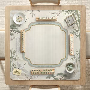 May include: A square mahjong play mat featuring a cream-colored surface with illustrations of cranes, bamboo, and pine trees. The mat includes wooden tile racks, a small bowl of mahjong tiles, a bowl of green glass beads, and the text PLAY RIGHT WALLS LEFT.