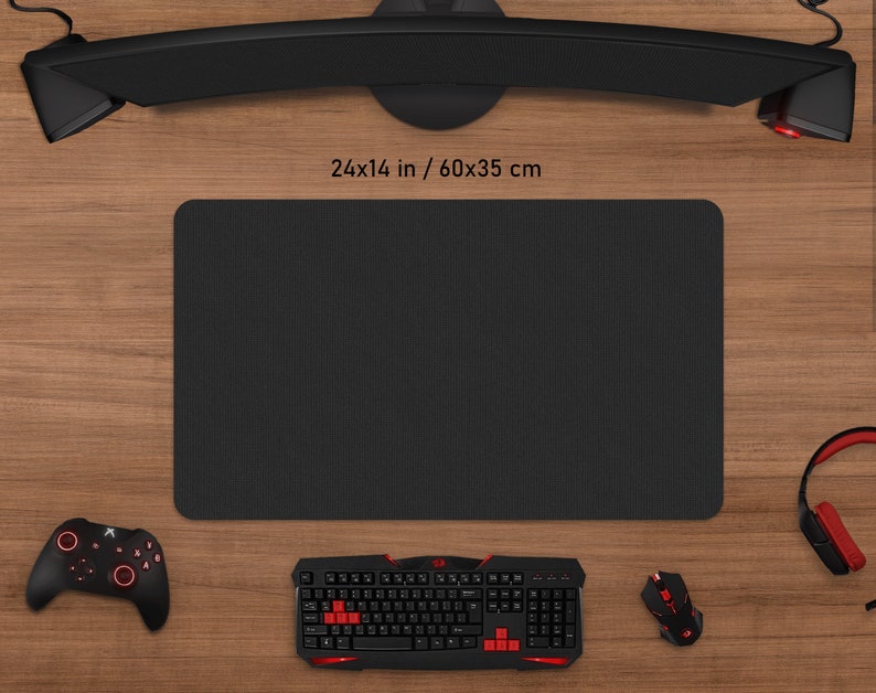 May include: A black rectangular mouse pad, 24 x 14 inches, with a textured surface, surrounded by gaming accessories. A black keyboard with red accents, a mouse, a controller, and a headset are visible.