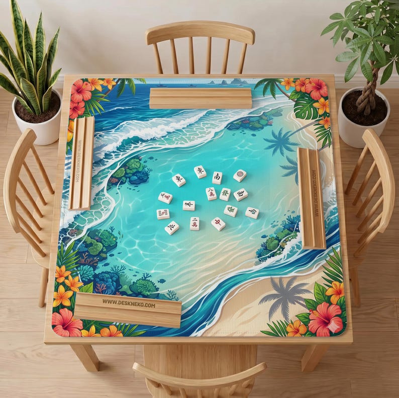 May include: A square mahjong mat featuring a tropical beach scene with turquoise water, coral reefs, and hibiscus flowers. The mat includes four wooden tile racks and scattered white mahjong tiles with black characters. Text reads WWW.DESKNEKO.COM.