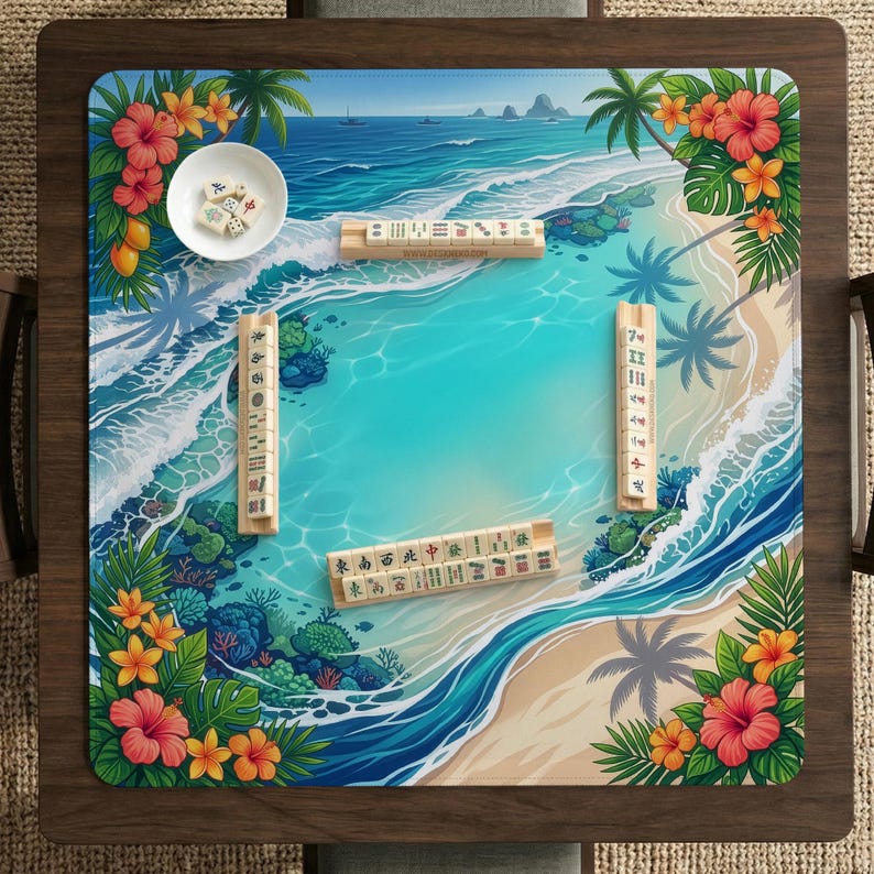 May include: A square Mahjong game board with a tropical beach scene. The board features a turquoise ocean, sandy beach, palm trees, and colorful flowers. Several Mahjong tiles and a small bowl with dice are arranged on the board.
