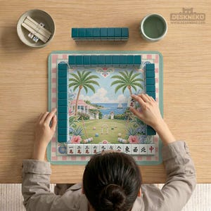 May include: A complete Mahjong set with teal tiles, dice, and a bowl. The game board features a tropical landscape with palm trees, a house, and a sailboat. The game is set on a wooden table.