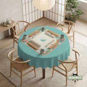 May include: A round teal tablecloth with a Mahjong game set in the center, surrounded by four wooden chairs. The Mahjong set has a white playing surface with a yin-yang symbol and is decorated with koi fish and lotus flowers.